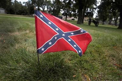 A Confederate Navy jack flag sits at the base of Confederate Mound, a memorial to more than 4,000 Confederate prisoners of war who died in captivity at Camp Douglas and are buried around the monument, on Aug. 23, 2017, in Chicago.