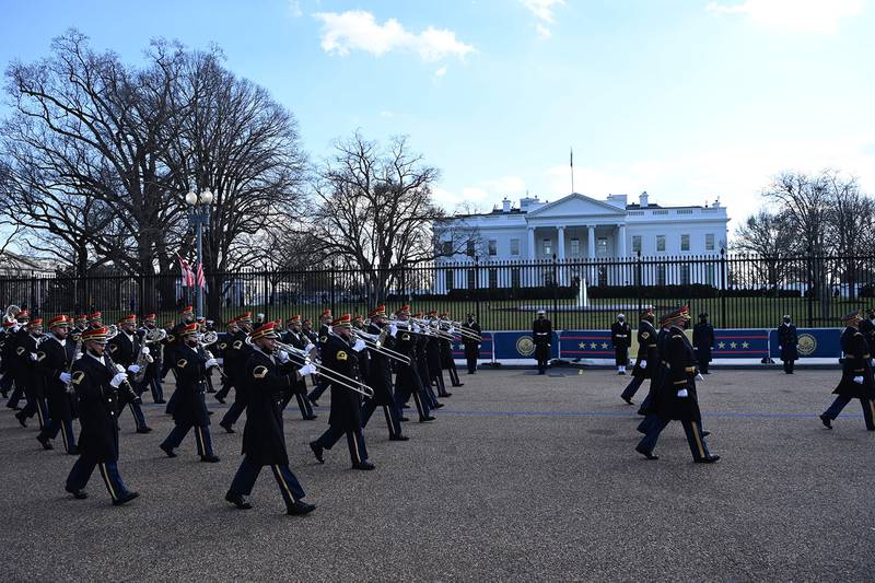 A military band parades on the street near the White House after President Joe Biden and Vice President Kamala Harris were sworn in at the Capitol on Jan. 20, 2021, in Washington.