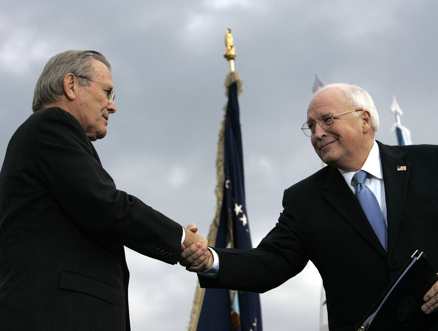 In this Dec. 15, 2006, file photo, outgoing Defense Secretary Donald H. Rumsfeld, left, shakes hands with Vice President Dick Cheney during an Armed Forces Full Honor Review for Rumsfeld at the Pentagon.