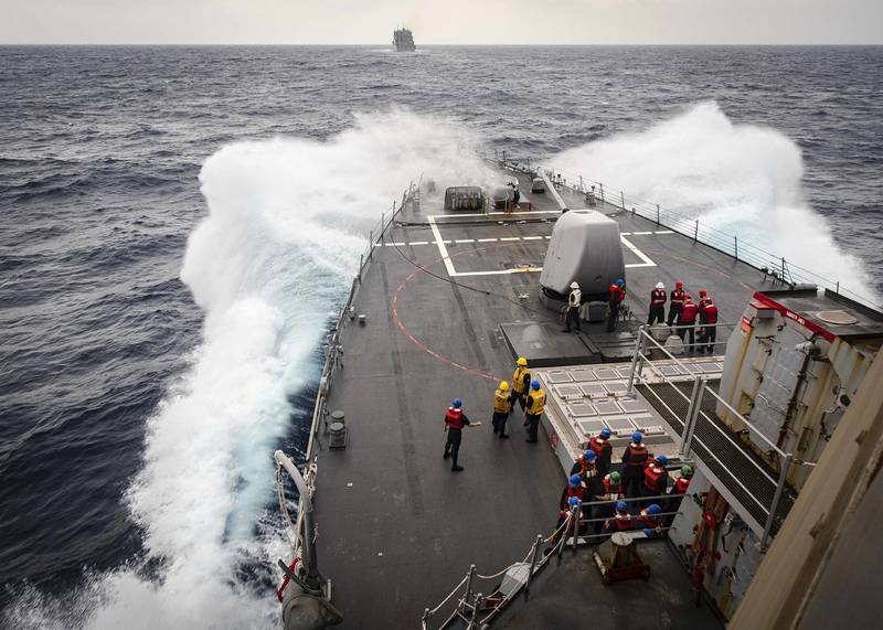 Sailors observe from the foc’s’le as the Arleigh Burke-class guided-missile destroyer USS John S. McCain (DDG 56) makes its approach towards the dry cargo and ammunition ship USNS Alan Shepard (T-AKE 3) prior to a replenishment-at-sea on Oct. 22, 2020, in the South China Sea.