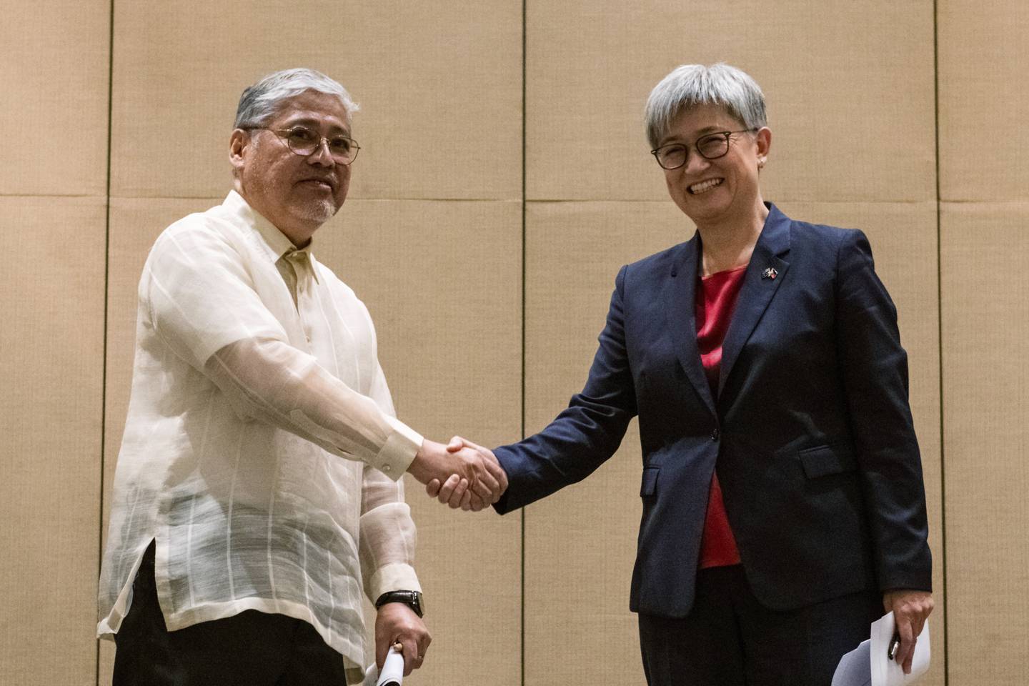 Australian Foreign Minister Penny Wong, right, shakes hands with Philippine Foreign Affairs Secretary Enrique Manalo during a joint press conference at a hotel in Makati City, Philippines on Thursday May 18, 2023.