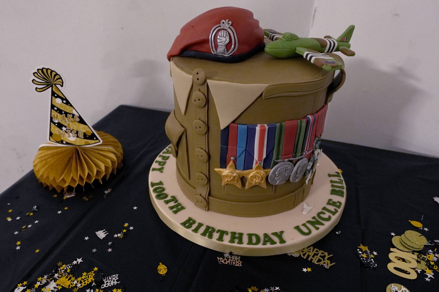 A birthday cake specially designed and made for D-Day veteran Bill Gladden surprises birthday party in Haverhill, England, Friday, Jan. 12, 2024.