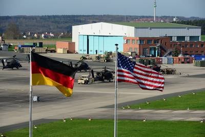 U.S. and German flags fly outside 12th Combat Aviation Brigade Headquarters overlooking the Katterbach Army Airfield in Ansbach, Germany