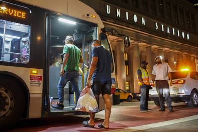 A group of people board a Chicago Transit Authority bus before being taken to a Salvation Army after arriving on a bus with other migrants from Texas at Union Station, Wednesday, Aug. 31, 2022, in Chicago.