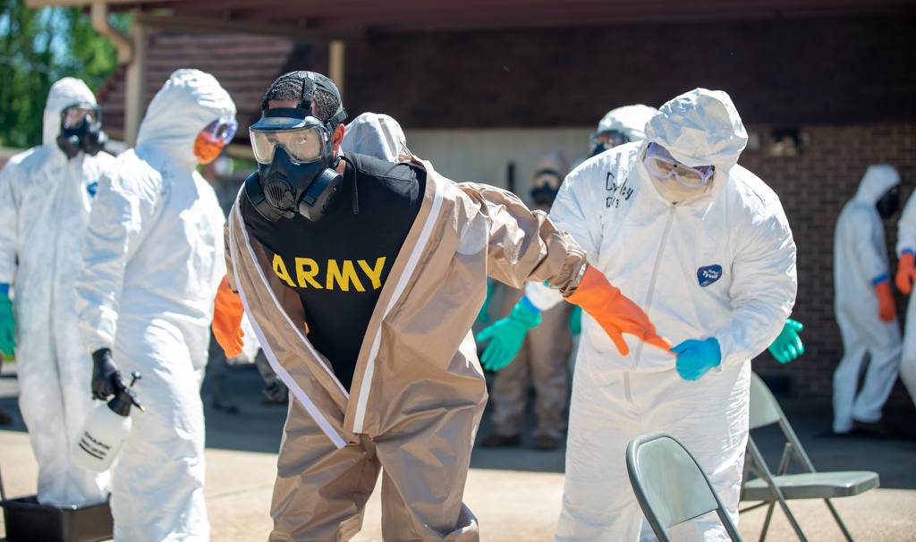 Sgt. Mason Moscatiello, a disinfection team specialist for Team 3 with Task Force 31, goes through the decontamination process, May 1, 2020, in Aliceville, Ala.