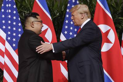 In this June 12, 2018, file photo, President Donald Trump, right, shakes hands with North Korea leader Kim Jong Un at the Capella resort on Sentosa Island in Singapore.