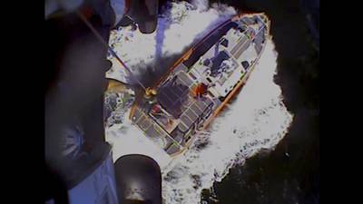 In this screenshot from video, the Coast Guard rescues boaters off the coast of Empire, La., on Sunday, Oct. 9, 2022.