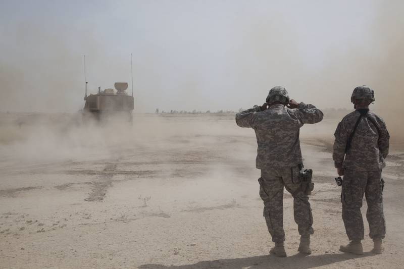 U.S. Army soldiers cover their ears during an artillery qualification at Besamaya Range in FOB Hammer, Iraq, May 6, 2011.