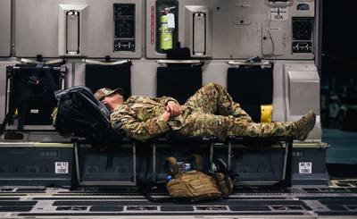 An airman sleeps inside a C-17 Globemaster III during a flight over an undisclosed location in support of Operation Freedom Sentinel, Jan. 22, 2018. (Staff Sgt. Jordan Castelan/Air Force)