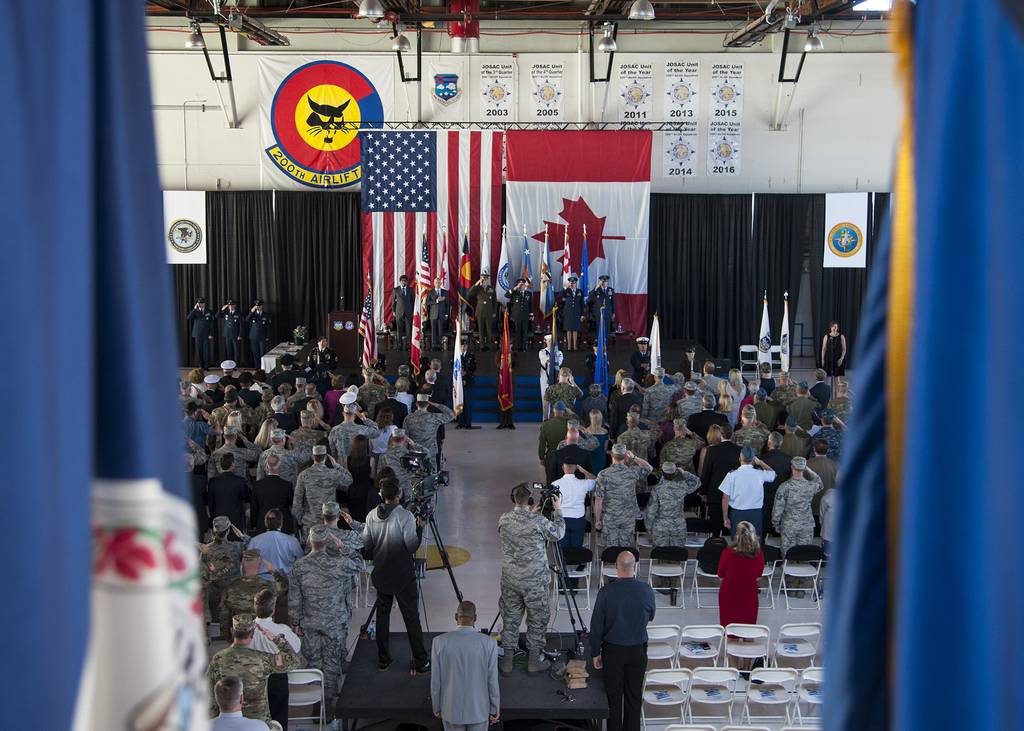 Members of both the North American Aerospace Defense Command and Northern Command, and international dignitaries from Mexico and Canada pay respects during the playing of the national anthem at the NORAD and USNORTHCOM change of command ceremony held on Peterson Air Force Base, Colo., May 24, 2018.