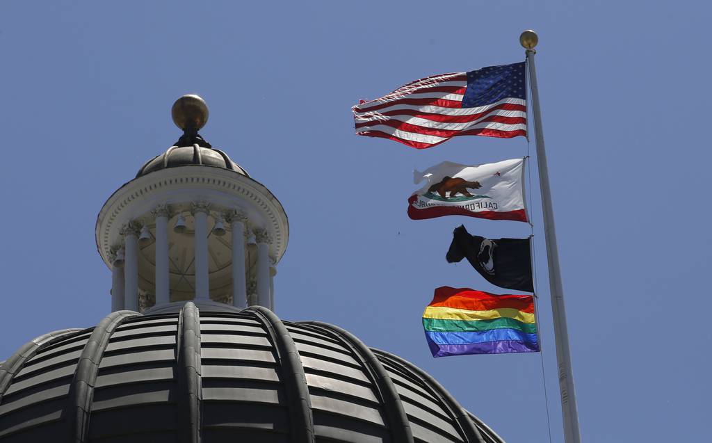 The rainbow Pride flag flutters from the flag pole at the state Capitol in Sacramento, Calif., Monday, June 17, 2019.