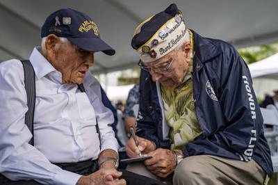 Pearl Harbor survivors Harry Chandler, 102, left, and Herb Elfring, 101, talk to each other during the 82nd Pearl Harbor Remembrance Day ceremony on Thursday, Dec. 7, 2023, at Pearl Harbor in Honolulu, Hawaii.