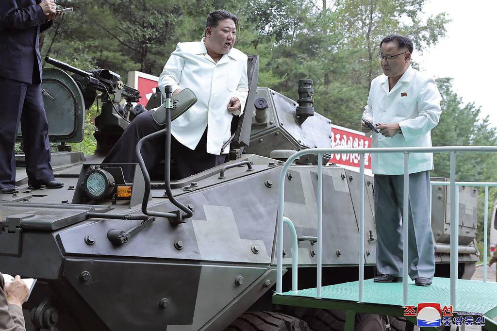In this undated photo provided on Monday, Aug. 14, 2023, by the North Korean government, North Korean leader Kim Jong Un, center, rides on an armored vehicle during his Aug. 11-12 visit to a military factory in North Korea.