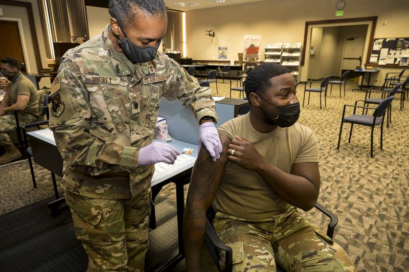 Senior Airman Rendall Powell of the 412th Test Wing receives a COVID-19 vaccination shot from Lt. Col. Yvonne Storey at Edwards Air Force Base, California, Aug. 25, 2021. (Katherine Franco/Air Force)