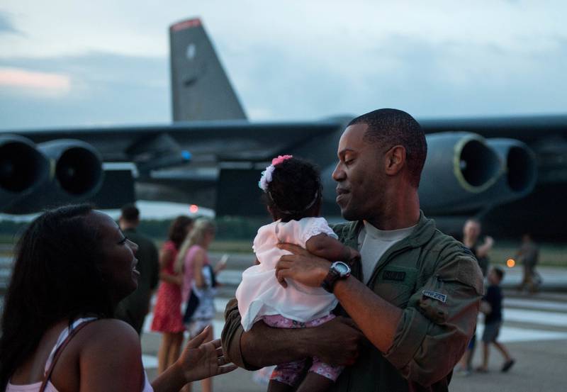 Capt. Donovan Carroll, 20th Bomb Squadron, embraces his daughter Colby for the first time at Barksdale Air Force Base, La., July 12, 2018. His wife Bree was six months pregnant with Colby when Carroll left for his deployment. (Airman 1st Class Tessa B. Corrick/Air Force)