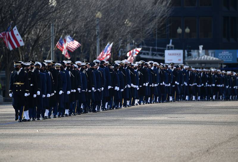 An honor guard deploys to line up along Pennsylvania Avenue in front of the White House in Washington on Jan. 20, 2021.