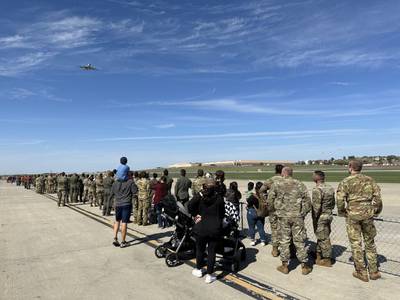The first plane to land on Offutt Air Force Base’s new runway flies over a ceremonial crowd before making a final approach on Friday, Sept. 30, 2022.