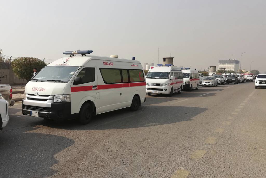 Ambulances line up in front of a headquarters of the Popular Mobilization Force after it was hit by an airstrike in Baghdad, Iraq, Thursday, Jan. 4, 2024.