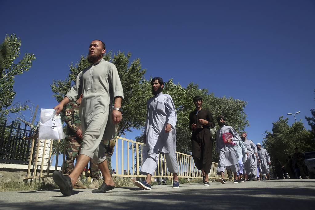 Afghan Taliban prisoners freed from Bagram Prison walk in Kabul, Afghanistan, Tuesday, May 26, 2020.