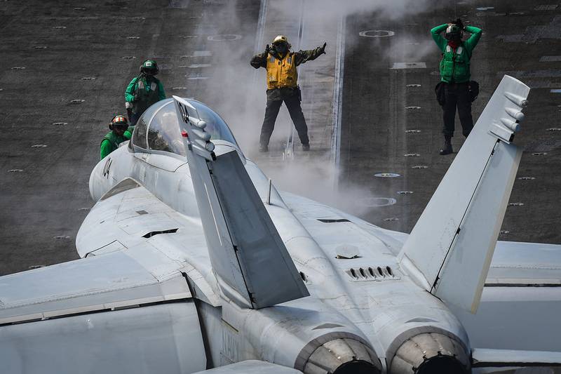 Sailors direct an F/A-18F Super Hornet on June 30, 20109, on the flight deck of the aircraft carrier USS Theodore Roosevelt (CVN 71) in the Pacific Ocean.