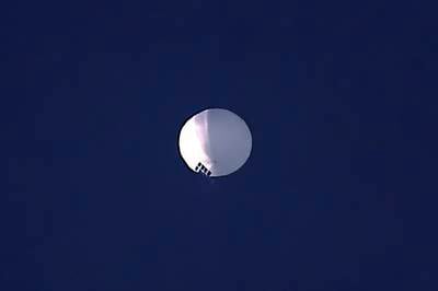 A high altitude balloon floats over Billings, Mont., on Wednesday, Feb. 1, 2023. The huge, high-altitude Chinese balloon sailed across the U.S. on Friday, drawing severe Pentagon accusations of spying and sending  excited or alarmed Americans outside with binoculars.