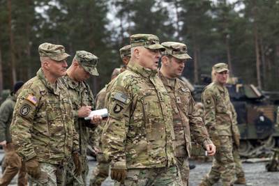 In this image provided by the U.S. Army, U.S. Chairman of the Joint Chiefs of Staff Gen. Mark Milley meets with U.S. Army leaders responsible for the collective training of Ukrainians at Grafenwoehr Training Area, Grafenwoehr, Germany, on Monday, Jan. 16, 2023.