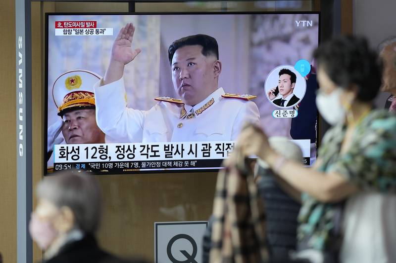 A TV screen showing a news program reporting about North Korea's missile launch with file footage of North Korean leader Kim Jong Un, is seen at the Seoul Railway Station in Seoul, South Korea, Tuesday, Oct. 4, 2022.