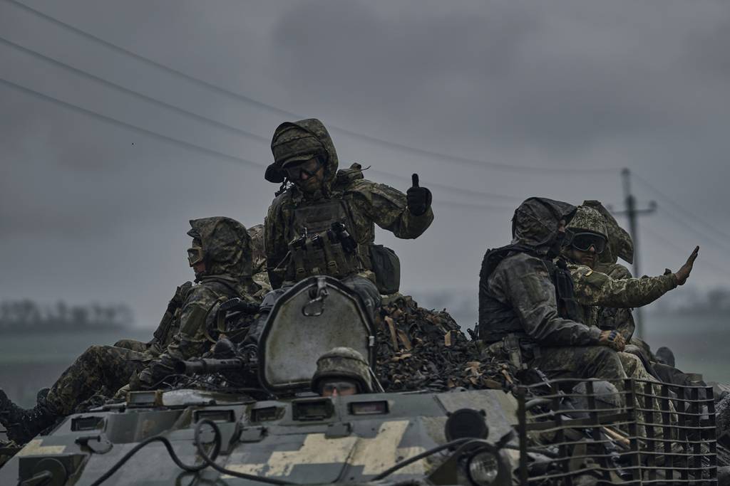 Ukrainian servicemen ride atop by an APC towards frontline positions near Vuhledar, Donetsk region, Ukraine, Monday, May 1, 2023.