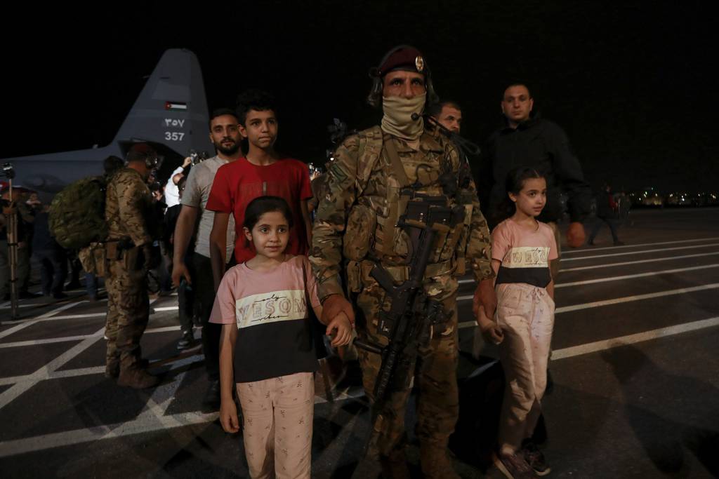 Jordanians evacuated from Sudan arrive at a military airport in Amman, Jordan, Monday, April 24, 2023.
