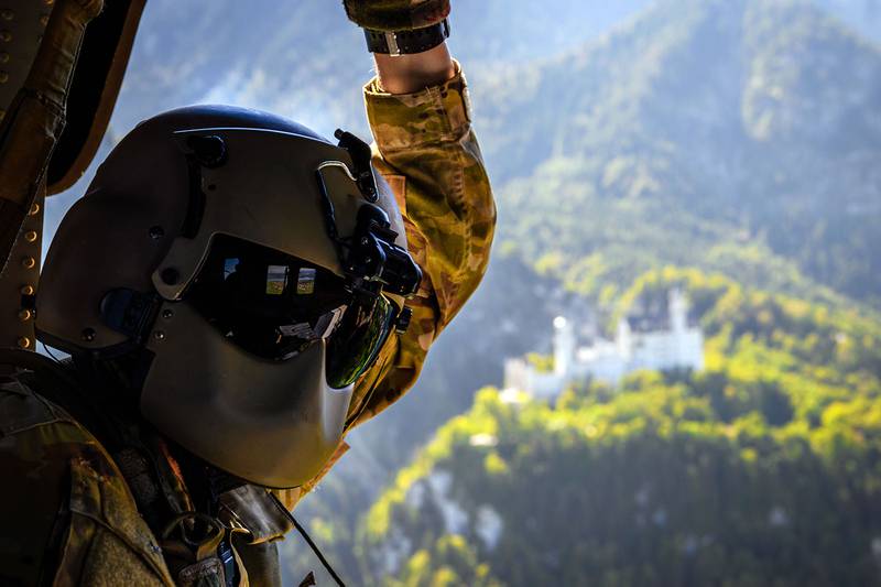 U.S. Army Spc. Dorian Sonneman, a crew chief with Alpha Company, 6th Battalion, 101st Combat Aviation Brigade, passes by Neuschwanstein Castle while transporting COVID-19 tests to Landstuhl Regional Medical Center during Combined Resolve XIV, Sep. 15, 2020, at Hohenfels Training Area.