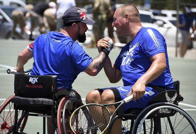 From left: Cpl. John Willans, Team United Kingdom, and Staff Sgt. Brian Biviano celebrate after they won their final match of wheelchair tennis