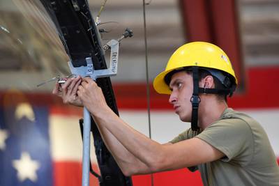 Senior Airman Andres Espinoza, 31st Maintenance Squadron egress journeyman, pins a canopy support strut on an F-16 Fighting Falcon at Aviano Air Base, Italy, Aug. 11, 2022. Egress specialists perform inspections and maintenance on F-16 canopies and egress systems to ensure the components function properly in flight and during emergencies. (Senior Airman Brooke Moeder/Air Force)