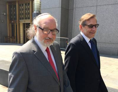 In this July 22, 2016, file photo, convicted spy Jonathan Pollard, left, with his lawyer, Eliot Lauer, leaves federal court in New York following a hearing.