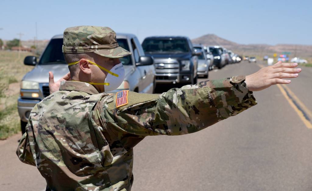 Arizona National Guard service members direct visitor check-in at a temporary COVID-19 testing site on the Navajo Nation May 19, 2020, in Tonalea, Ariz.