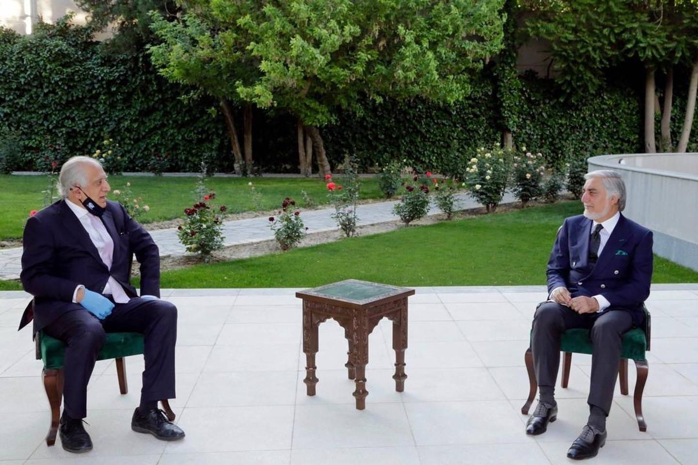 In this Wednesday, May 20, 2020, photo, Abdullah Abdullah, right, President Ashraf Ghani's fellow leader under a recently signed power-sharing agreement, holds a meeting with U.S. peace envoy Zalmay Khalilzad aimed at resuscitating a U.S.-Taliban peace deal signed in February, at the presidential palace, in Kabul, Afghanistan.