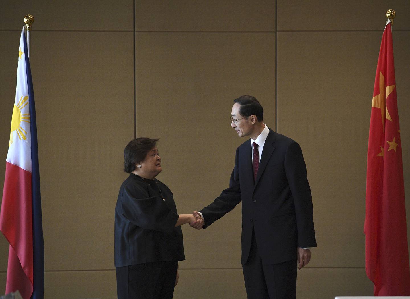 Theresa Lazaro, left, Philippines' Undersecretary for Bilateral Relations and Asian Affairs of the Department of Foreign Affairs, shake hands with Sun Weidong, China's Vice Foreign Minister, prior to the start of the Philippines-China Foreign Ministry consultation meeting at a hotel in Manila on Thursday, March 23, 2023.