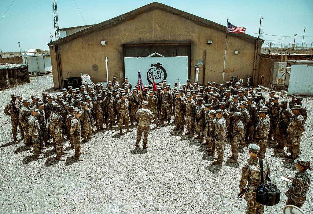Maj. Gen. Flem B. "Donnie" Walker, commanding general of 1st Theater Sustainment Command, speaks with Task Force Cavalier Soldiers of the 529th Support Battalion, 574th Quartermaster Company, and 183d Maintenance Company at Camp Taji, Iraq, June 8, 2019.