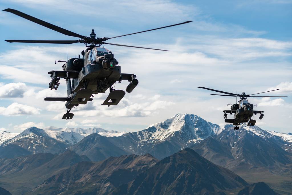 Army AH-64D Apache Longbow attack helicopters assigned to 1st Battalion, 25th Aviation Regiment Attack Reconnaissance Battalion in flight over an Alaskan mountain range near Fort Wainwright, Alaska, June 3, 2019.