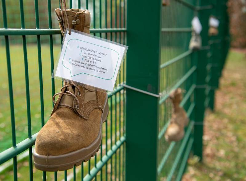 A wall of boots representing individuals affected by sexual misconduct is on display at a sexual assault awareness event at Ramstein Air Base, Germany, April 14, 2022. (Airman 1st Class Jordan Lazaro/Air Force)