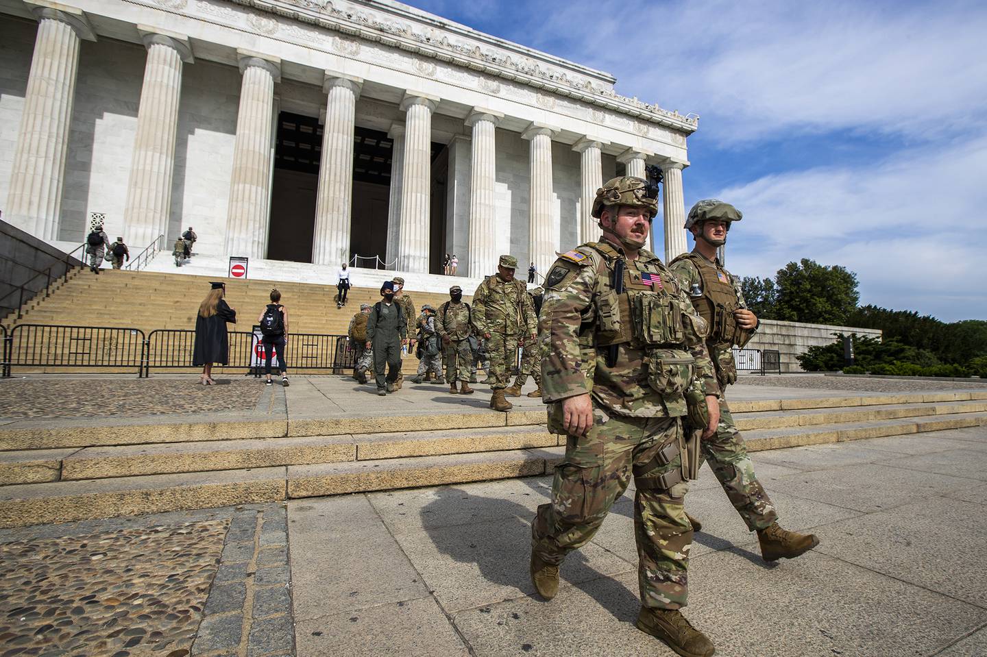 Members of the District of Columbia Army National Guard walk to their designated positions at the National Mall near the Lincoln Memorial in Washington, Wednesday, June 3, 2020, securing the area as protests continue following the death of George Floyd, a who died after being restrained by Minneapolis police officers.