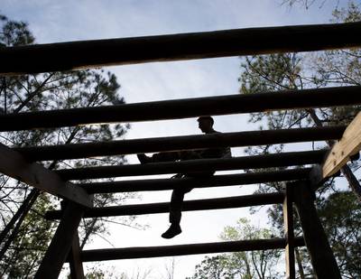 A service member works through an obstacle on an obstacle course during an event at Camp Shelby Joint Forces Training Center, Mississippi, March 21, 2023.