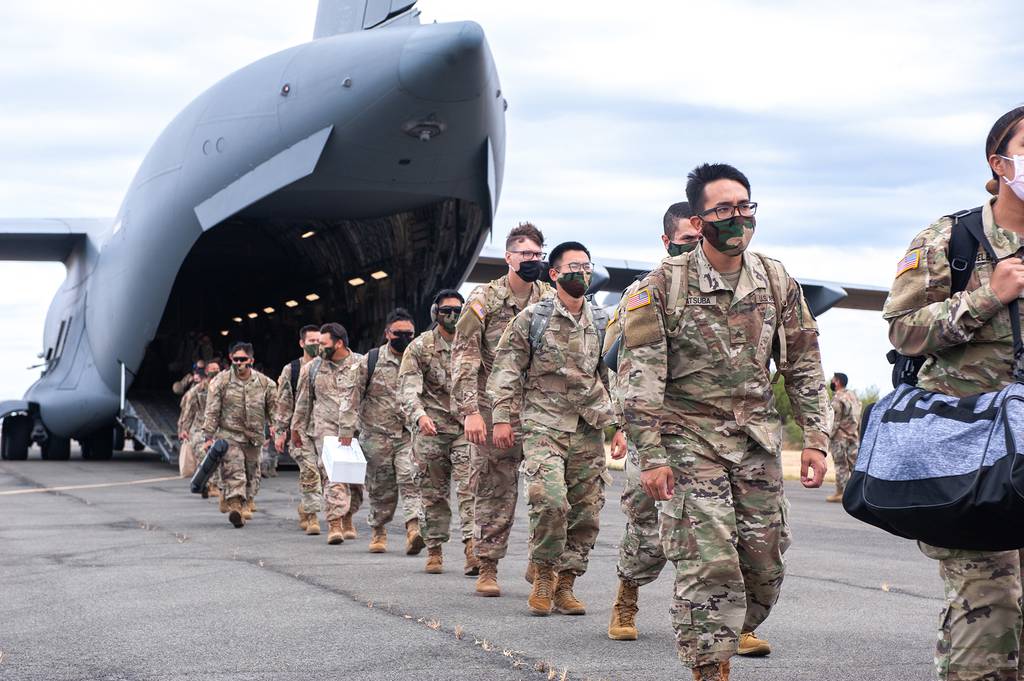 Hawaii National Guard soldiers and airmen depart a C-17 Globemaster III May 26, 2020, Kapolei, Hawaii.
