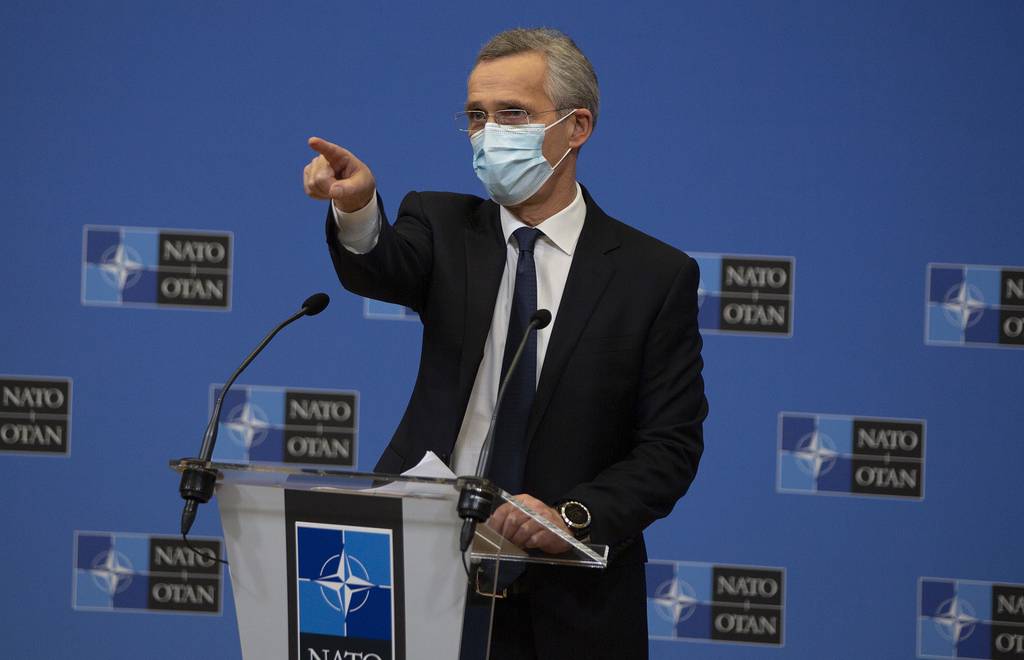 NATO Secretary General Jens Stoltenberg wears a protective face mask as he prepares to speak during a media conference at NATO headquarters in Brussels on Thursday, Feb. 18, 2021.