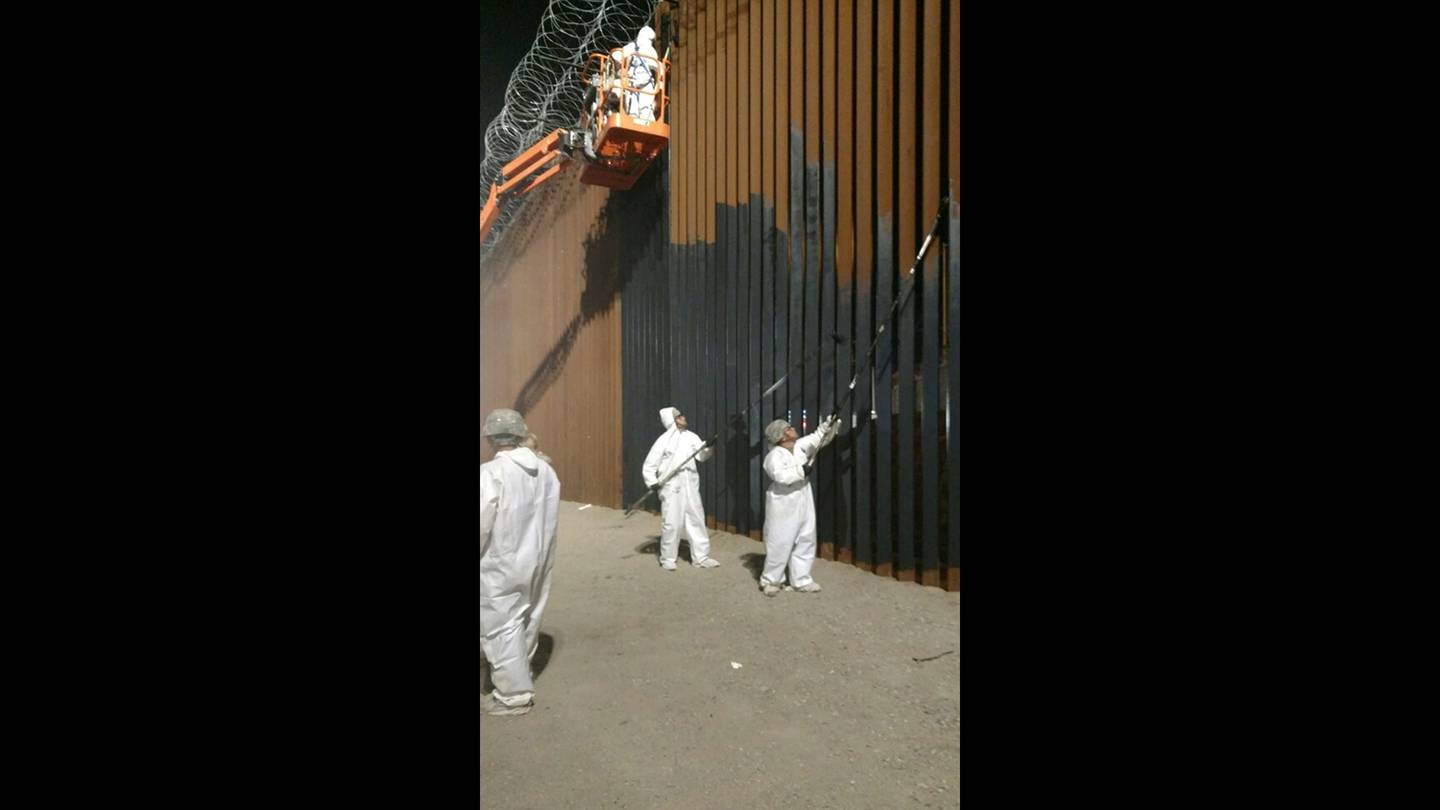 Soldiers from the 15th Engineering Company apply paint to bollard wall near the Calexico West port of entry on June 11, 2019.
