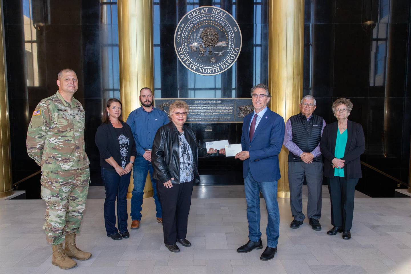 Gov. Doug Burgum presents Ron Hepper’s military ID tag to his widow, Ruth Hepper of Bismarck, on Wednesday, Sept. 30, at the Capitol in Bismarck.