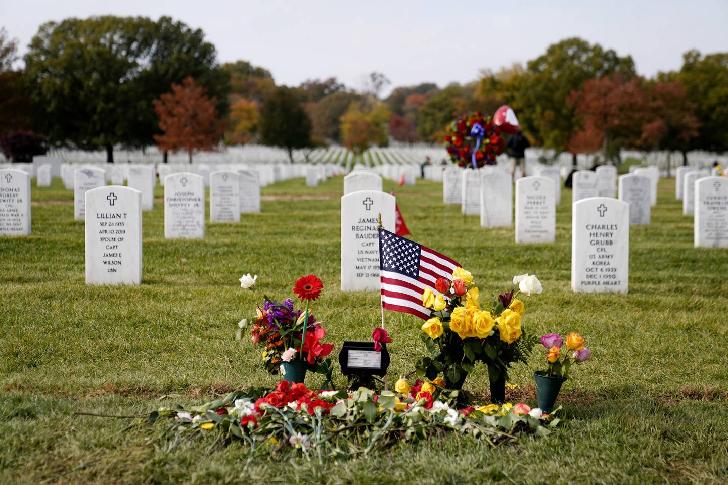 Flowers rest at the burial plot of former Secretary of State Colin Powell in Section 60 at Arlington National Cemetery, Nov. 11, 2021, in Arlington, Va.