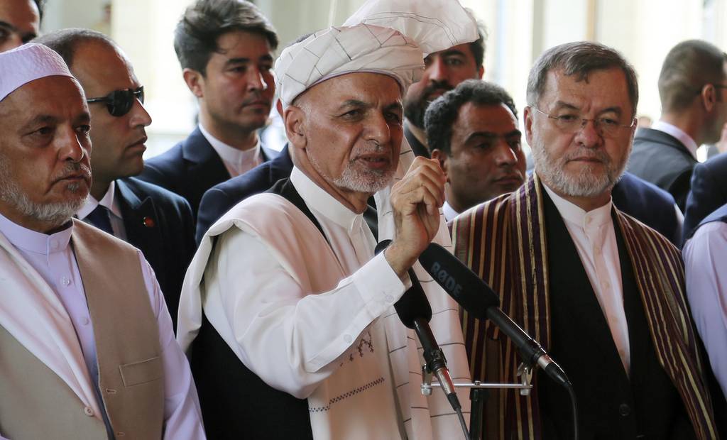 Afghanistan's President Ashraf Ghani, center, speaks after offering Eid al-Adha prayers at the presidential palace in Kabul, Afghanistan, Sunday, Aug. 11, 2019.