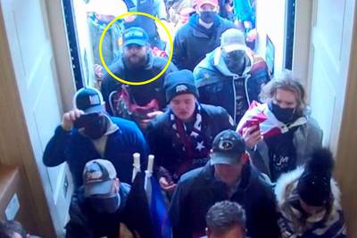 In this image from U.S. Capitol Police security video, released and annotated by the Justice Department in the Statement of Facts supporting an arrest warrant, Taylor Taranto, circled in yellow, enters the U.S. Capitol through the Upper West Terrace door on Jan. 6, 2021, in Washington