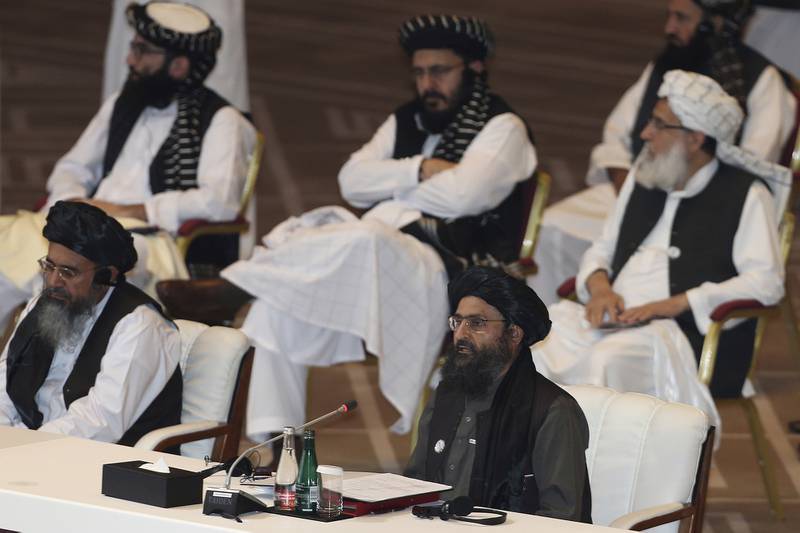 In this Sept. 12, 2020, file photo, Taliban co-founder Mullah Abdul Ghani Baradar, bottom right, speaks at the opening session of peace talks between the Afghan government and the Taliban in Doha, Qatar.