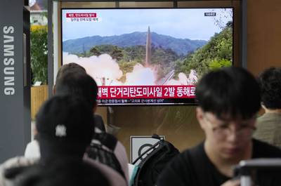A TV screen shows a file image of North Korea's missile launch during a news program at the Seoul Railway Station in Seoul, South Korea, Wednesday, July 19, 2023.